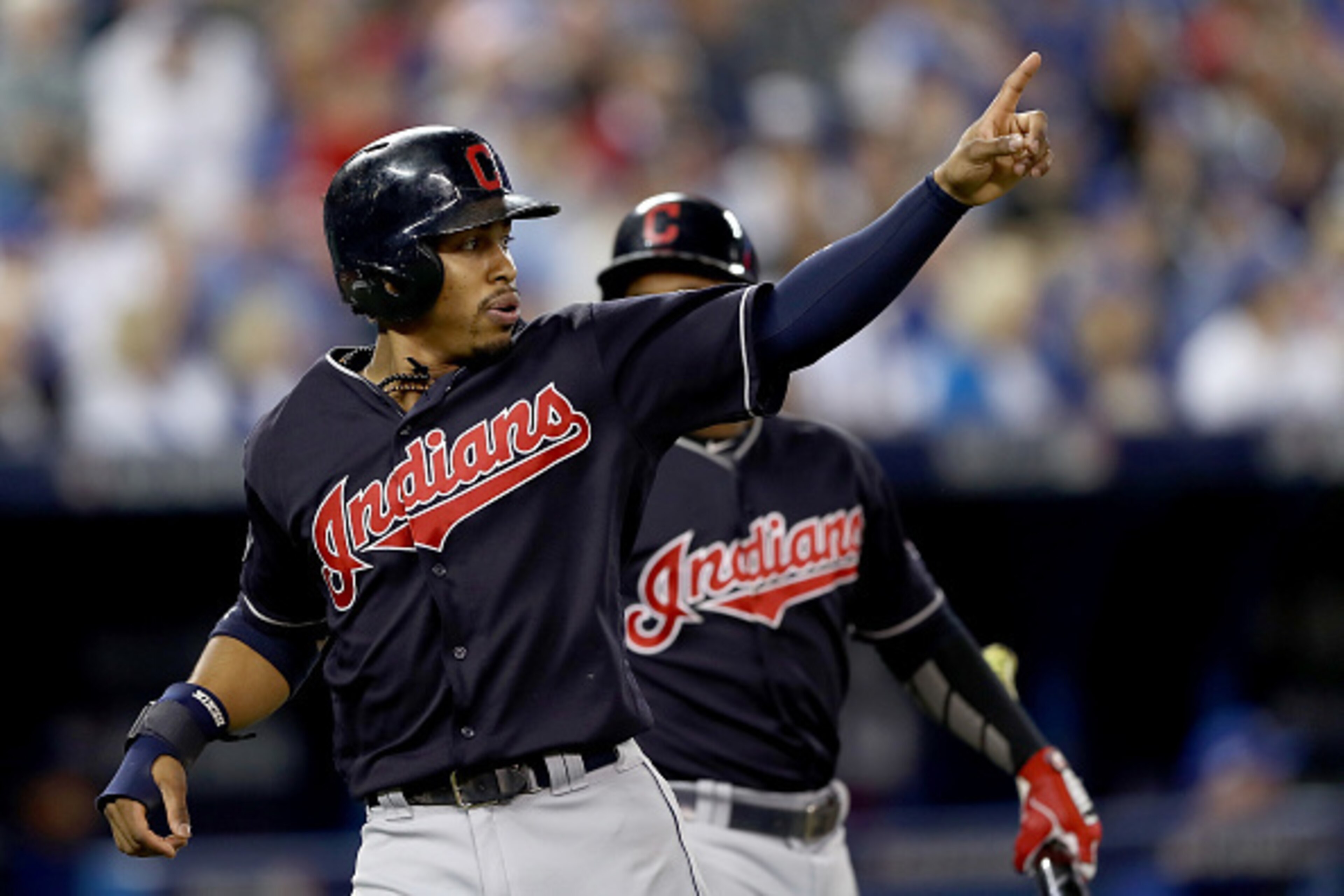 TORONTO, ON - OCTOBER 19:  Francisco Lindor #12 of the Cleveland Indians celebrates after scoring a run off of a double hit by Mike Napoli #26 in the first inning against Marco Estrada #25 of the Toronto Blue Jays during game five of the American League C