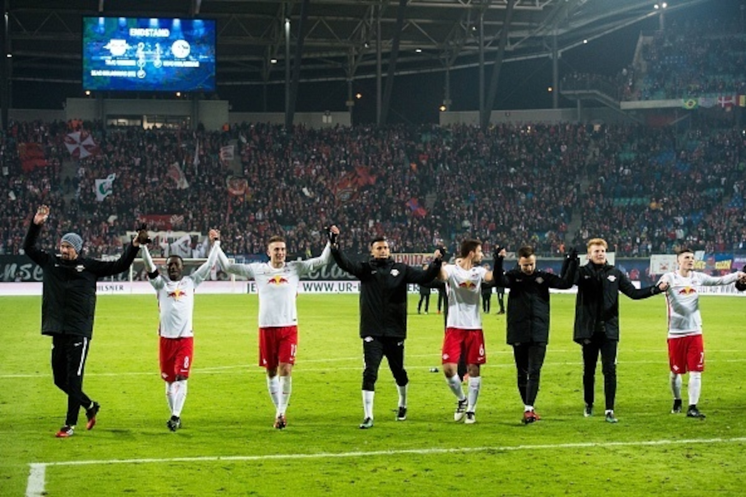 Players of RB Leipzig celebrate after the German first division Bundesliga football match between RB Leipzig and Schalke 04 in Leipzig, eastern Germany on December 3, 2016.  / AFP / JENS SCHLUTER / RESTRICTIONS: DURING MATCH TIME: DFL RULES TO LIMIT THE O