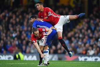 LONDON, ENGLAND - OCTOBER 23: Chris Smalling of Manchester United and Daley Blind of Manchester United tackle Diego Costa of Chelsea during the Premier League match between Chelsea and Manchester United at Stamford Bridge on October 23, 2016 in London, En