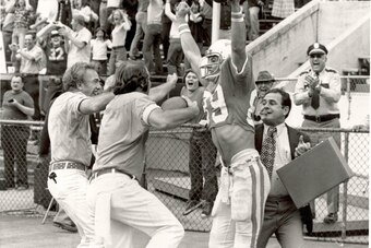 Manning (far right) celebrates a touchdown with receiver Larry Seivers after his game-winning two-point conversion catch from Condredge Holloway to beat Clemson 29-28 in 1974.