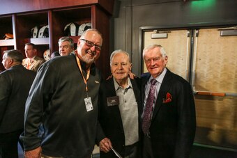 Manning (center) stands with UT head equipment manager Roger Frazier (left) and longtime voice of the Vols John Ward (right).