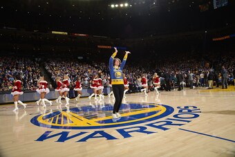 OAKLAND, CA - DECEMBER 20:  Dancing Warriors mom Robin Schreiber dances with the Warriors dance team during the game between the Golden State Warriors and Utah Jazz on December 20, 2016 at ORACLE Arena in Oakland, California. NOTE TO USER: User expressly