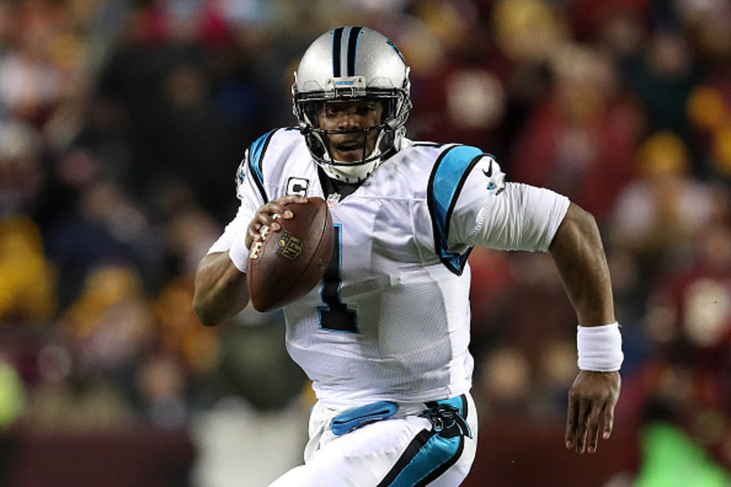 LANDOVER, MD - DECEMBER 19: Quarterback Cam Newton #1 of the Carolina Panthers scrambles with the ball against the Washington Redskins in the second quarter at FedExField on December 19, 2016 in Landover, Maryland. (Photo by Patrick Smith/Getty Images)