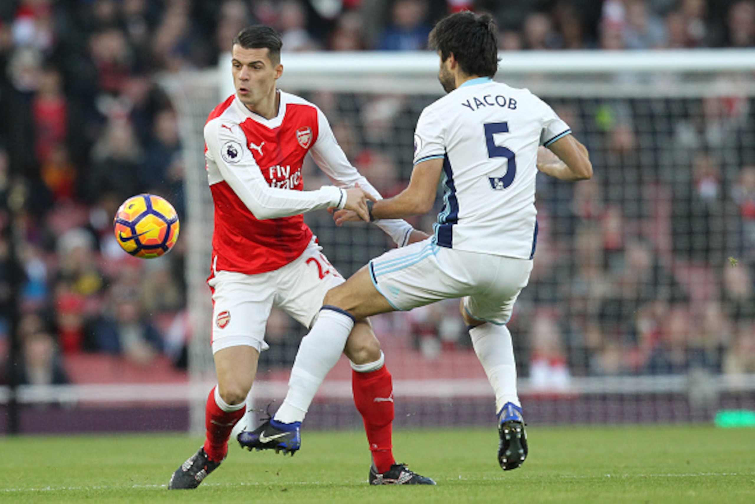 Arsenal's Swiss midfielder Granit Xhaka (L) vies with West Bromwich Albion's Argentinian midfielder Claudio Yacob during the English Premier League football match between Arsenal and West Bromwich Albion at the Emirates Stadium in London on December 26, 2