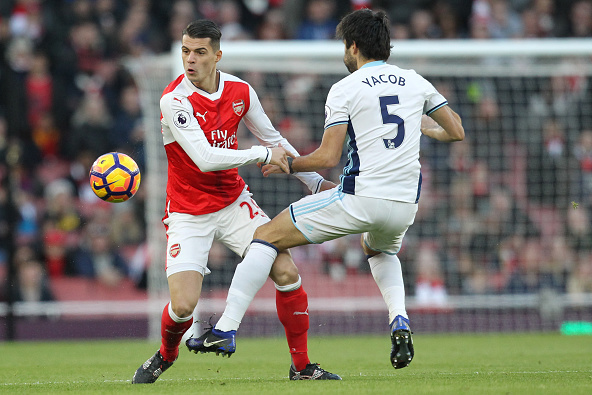Arsenal's Swiss midfielder Granit Xhaka (L) vies with West Bromwich Albion's Argentinian midfielder Claudio Yacob during the English Premier League football match between Arsenal and West Bromwich Albion at the Emirates Stadium in London on December 26, 2
