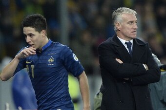 France's midfielder Samir Nasri (L) leaves the pitch next to France's head coach Didier Deschamps during the FIFA World Cup 2014 qualifying football match Ukraine vs France on November 15, 2013 at the Olympic stadium in Kiev.  AFP PHOTO / FRANCK FIFE     