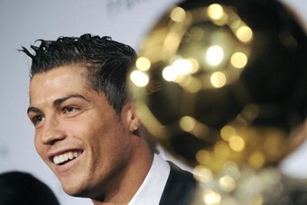 Manchester United Portuguese winger Cristiano Ronaldo smiles next to his trophy after he received the European footballer of the year award, the 'Ballon d'Or' (Golden ball), on December 7, 2008 in Boulogne-Billancourt, outside Paris. Ronaldo beat Barcelon