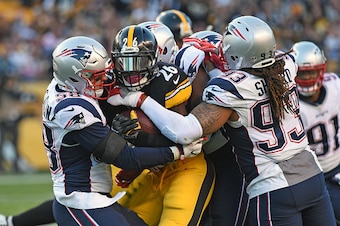PITTSBURGH, PA - OCTOBER 23: Linebacker Shea McClellin #58, cornerback Eric Rowe and defensive lineman Jabaal Sheard #93 of the New England Patriots tackle running back Le'Veon Bell #26 of the Pittsburgh Steelers during a game at Heinz Field on October 23