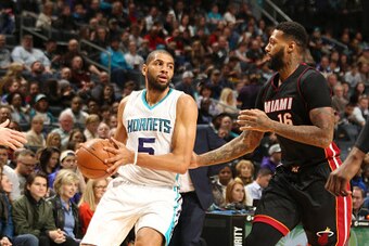 CHARLOTTE, NC - DECEMBER 29:  Nicolas Batum #5 of the Charlotte Hornets handles the ball against James Johnson #16 of the Miami Heat during the game on December 29, 2016 at Spectrum Center in Charlotte, North Carolina. NOTE TO USER: User expressly acknowl