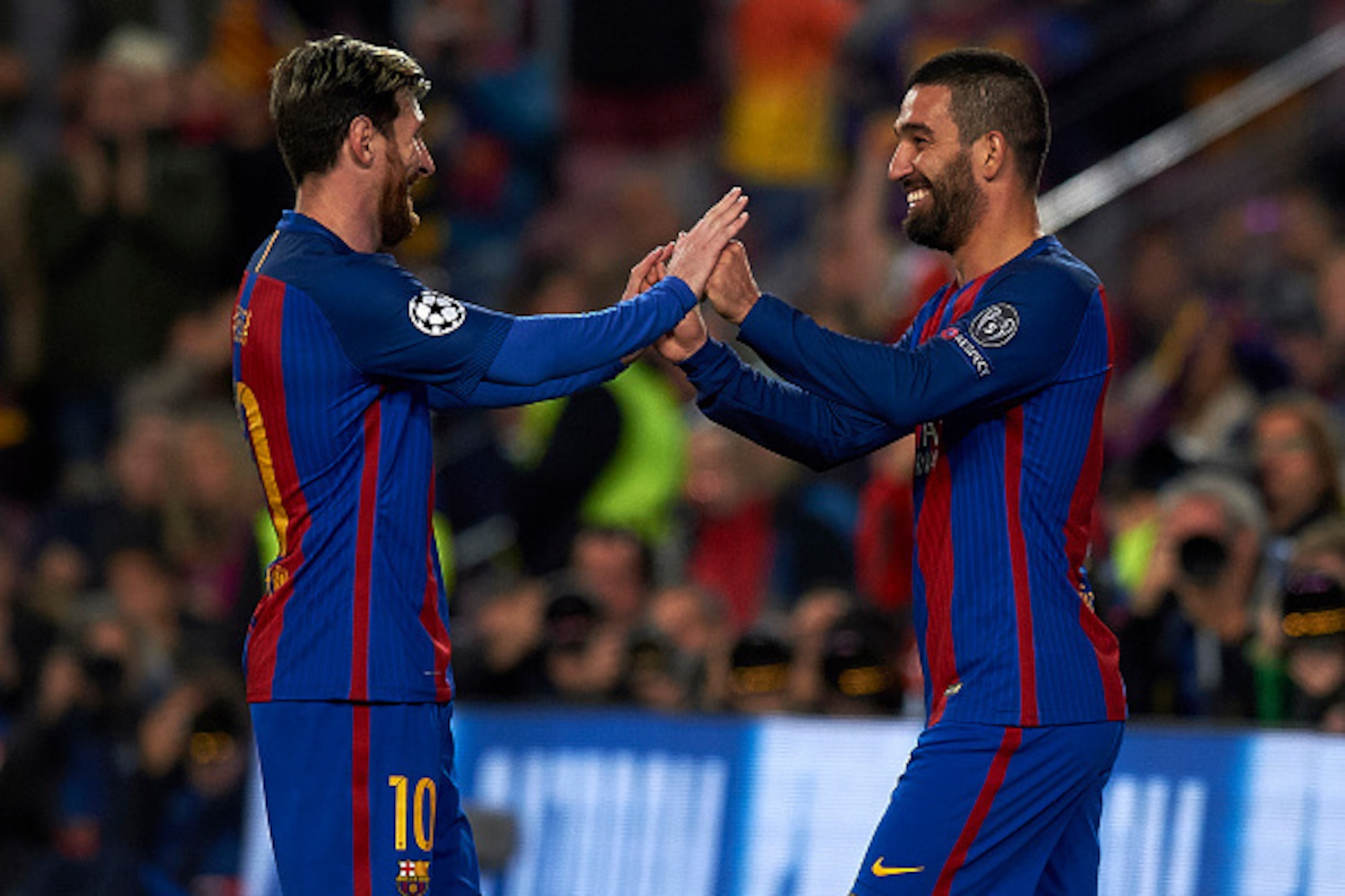 BARCELONA, SPAIN - DECEMBER 06:  Arda Turan (R) of Barcelona celebrates scoring his team's fourth goal with his teammate Lionel Messi during the UEFA Champions League Group C match between FC Barcelona and VfL Borussia Moenchengladbach at Camp Nou on Dece
