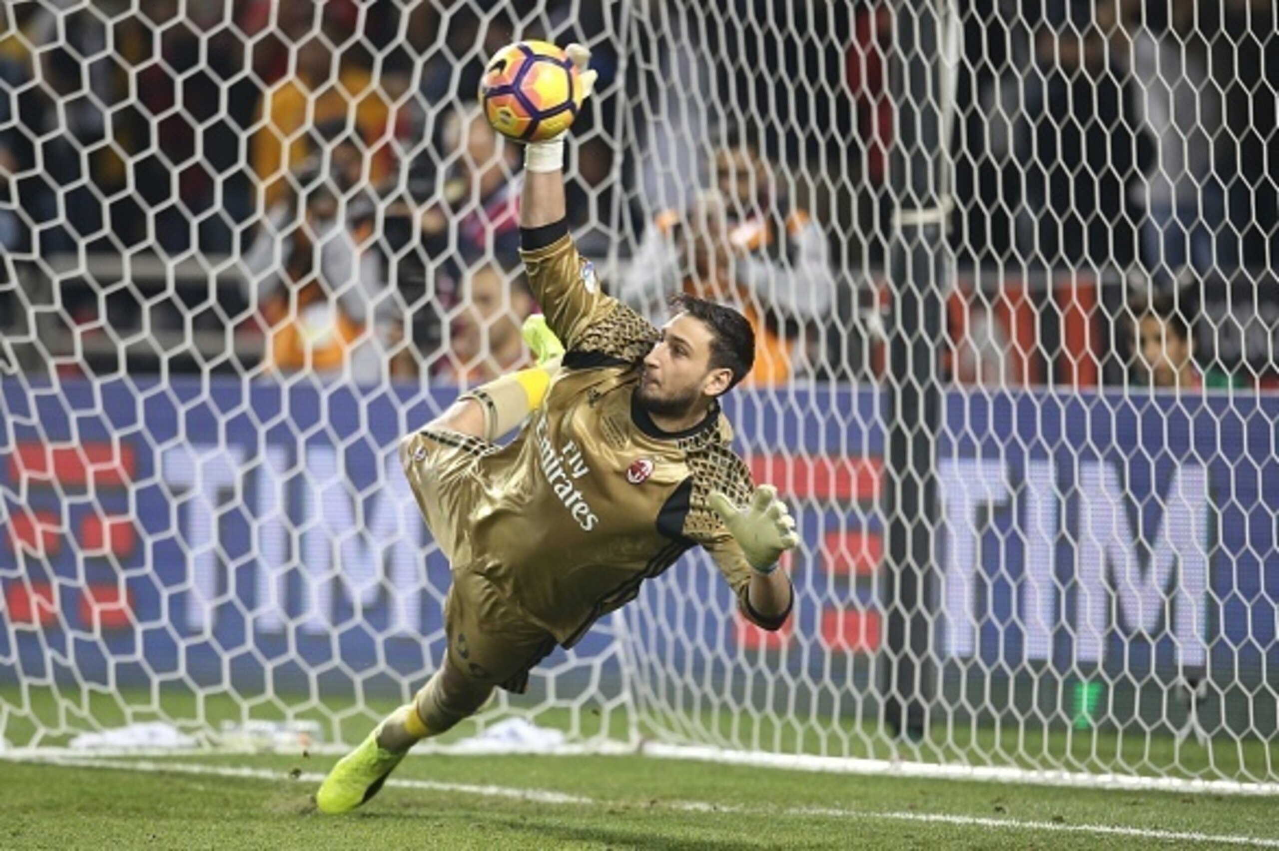 DOHA, QATAR - DECEMBER 23:  Gianluigi Donnarumma ,Goalkeeper of AC Milan saving the ball  from Juventus FC's Penalty   during the Supercoppa TIM Doha 2016 match between Juventus FC and AC Milan at the Jassim Bin Hamad Stadium on December 23, 2016 in Doha,