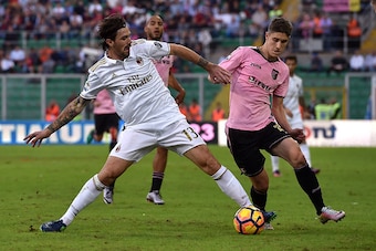 PALERMO, ITALY - NOVEMBER 06: Alessio Romagnoli (L) of Milan and Roland Sallai of Palermo compete for the ball during the Serie A match between US Citta di Palermo and AC Milan at Stadio Renzo Barbera on November 6, 2016 in Palermo, Italy.  (Photo by Tull