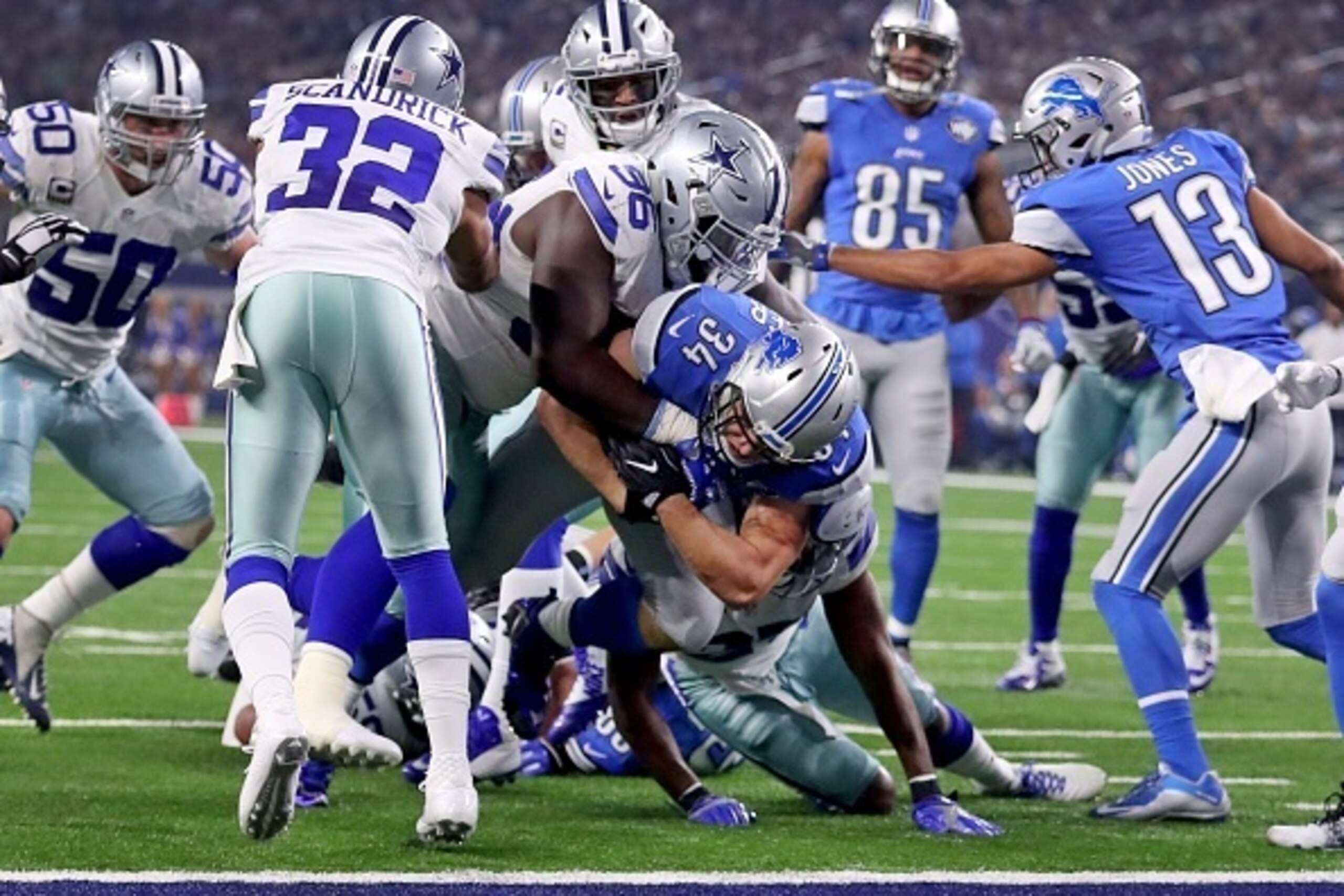 ARLINGTON, TX - DECEMBER 26: Zach Zenner #34 of the Detroit Lions scores on a touchdown run as Maliek Collins #96 of the Dallas Cowboys tries to stop him during the first half at AT&T Stadium on December 26, 2016 in Arlington, Texas. (Photo by Tom Penning