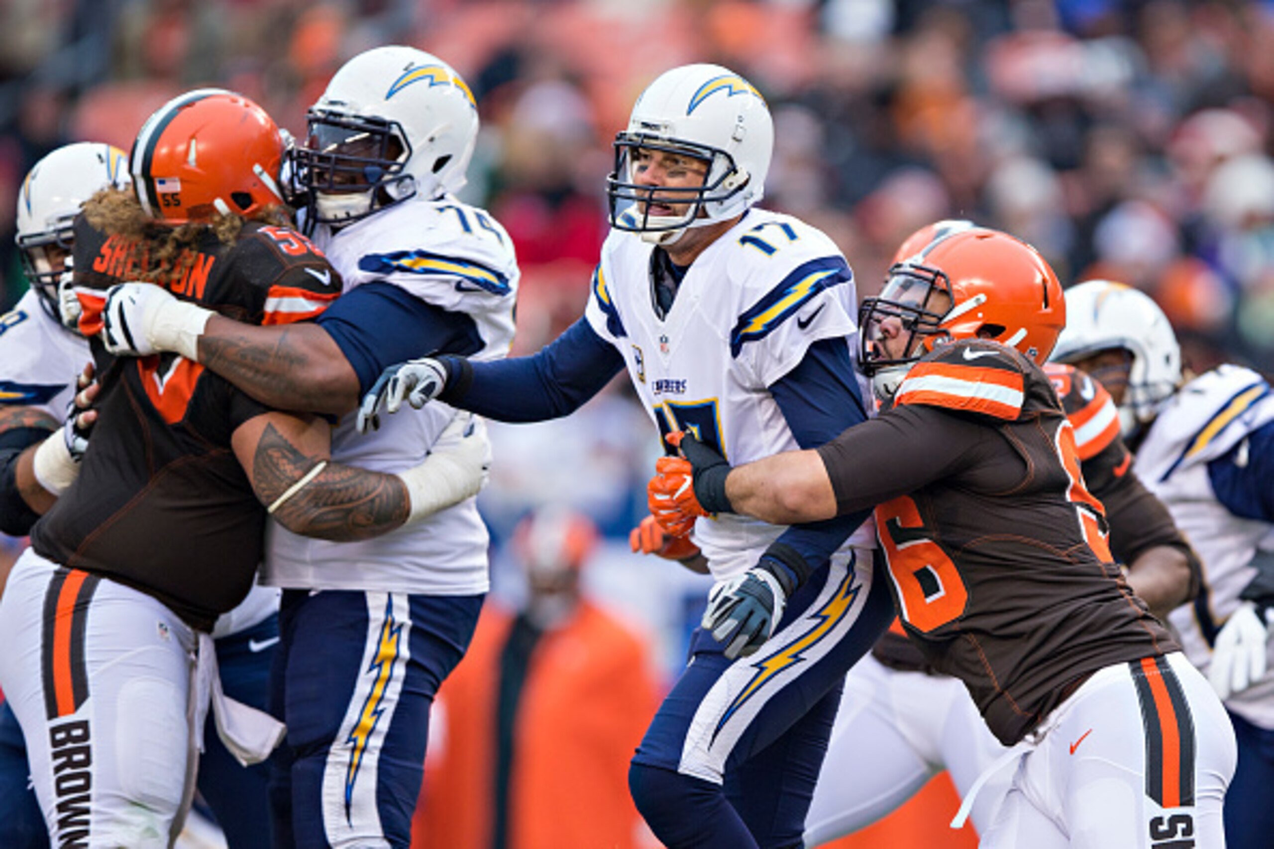 CLEVELAND, OH - DECEMBER 24:  Philip Rivers #17 of the San Diego Chargers throws a pass under pressure from Xavier Cooper #96 of the Cleveland Browns at FirstEnergy Stadium on December 24, 2016 in Cleveland, Ohio.  The Browns defeated the Chargers 20-17. 