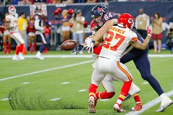 HOUSTON, TX - JANUARY 09:  Ryan Griffin #84 of the Houston Texans drops the ball as he is pressured by Tyvon Branch #27 and Husain Abdullah #39 of the Kansas City Chiefs during the fourth quarter of the AFC Wild Card Playoff game at NRG Stadium on January