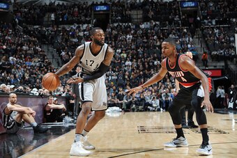 SAN ANTONIO, TX - DECEMBER 30:  Jonathon Simmons #17 of the San Antonio Spurs handles the ball against Maurice Harkless #4 of the Portland Trail Blazers during the game on December 30, 2016 at the AT&T Center in San Antonio, Texas. NOTE TO USER: User expr