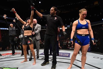 LAS VEGAS, NV - DECEMBER 30:  Amanda Nunes of Brazil (left) reacts to her victory over Ronda Rousey (right) in their UFC women's bantamweight championship bout during the UFC 207 event at T-Mobile Arena on December 30, 2016 in Las Vegas, Nevada.  (Photo b