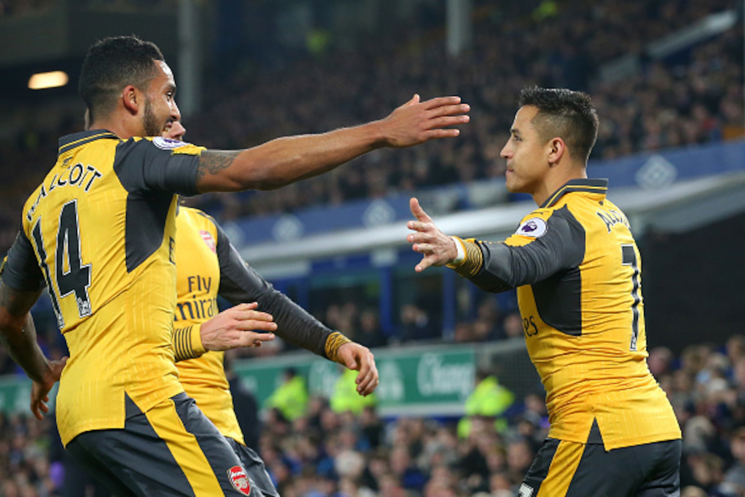 LIVERPOOL, ENGLAND - DECEMBER 13:  Alexis Sanchez (R) of Arsenal celebrates with teammate Theo Walcott  after scoring the opening goal during the Premier League match between Everton and Arsenal at Goodison Park on December 13, 2016 in Liverpool, England.
