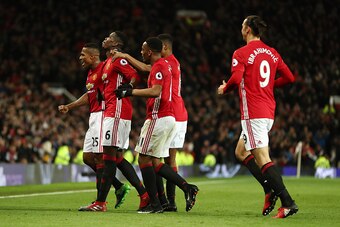 MANCHESTER, ENGLAND - DECEMBER 31: Paul Pogba of Manchester United celebrates with his team mates after scoring a goal to make it 2-1 during the Premier League match between Manchester United and Middlesbrough at Old Trafford on December 31, 2016 in Manch