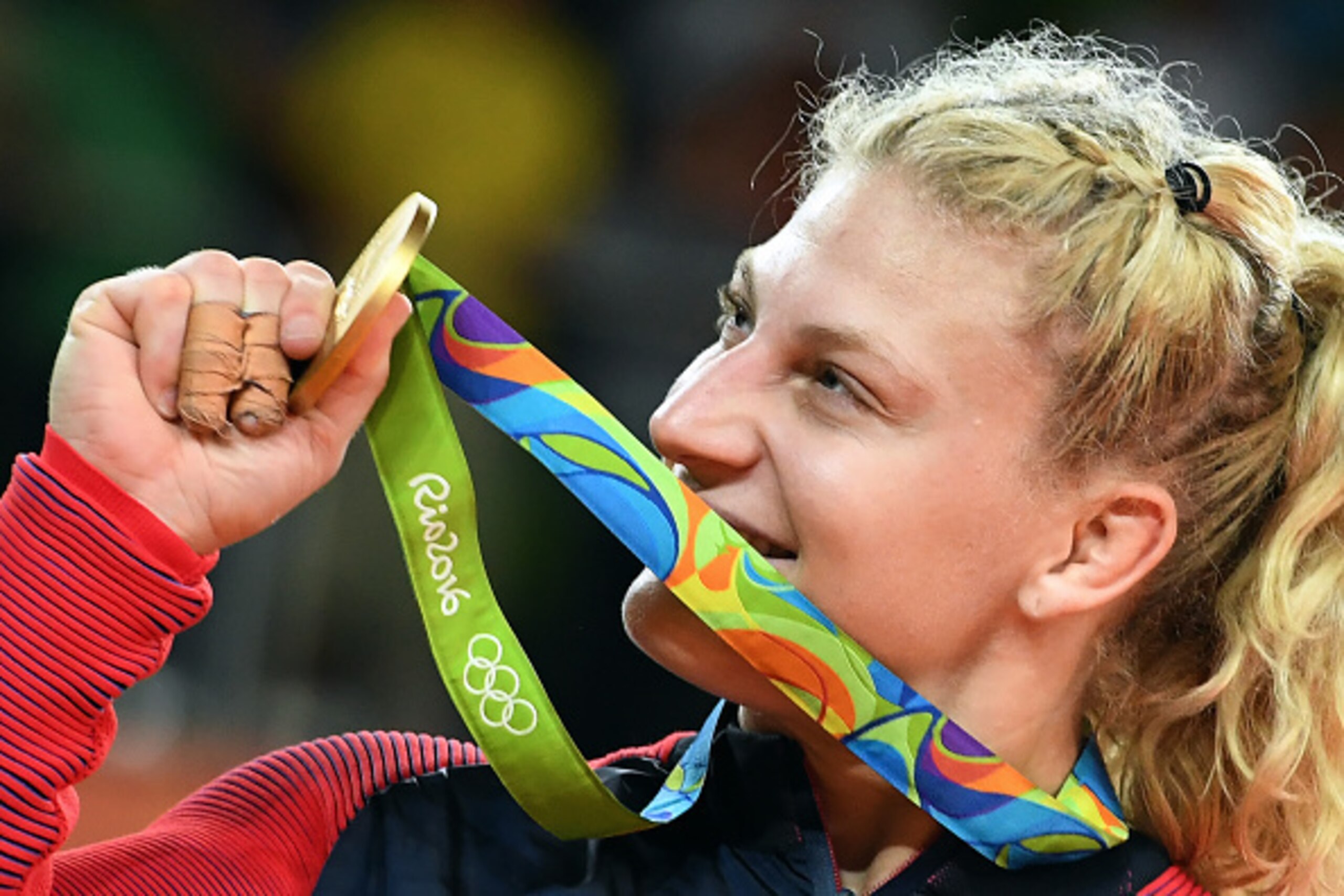 Gold medallist US Kayla Harrison celebrates on the podium of the women's -78kg judo contest of the Rio 2016 Olympic Games in Rio de Janeiro on August 11, 2016. / AFP / Toshifumi KITAMURA        (Photo credit should read TOSHIFUMI KITAMURA/AFP/Getty Images