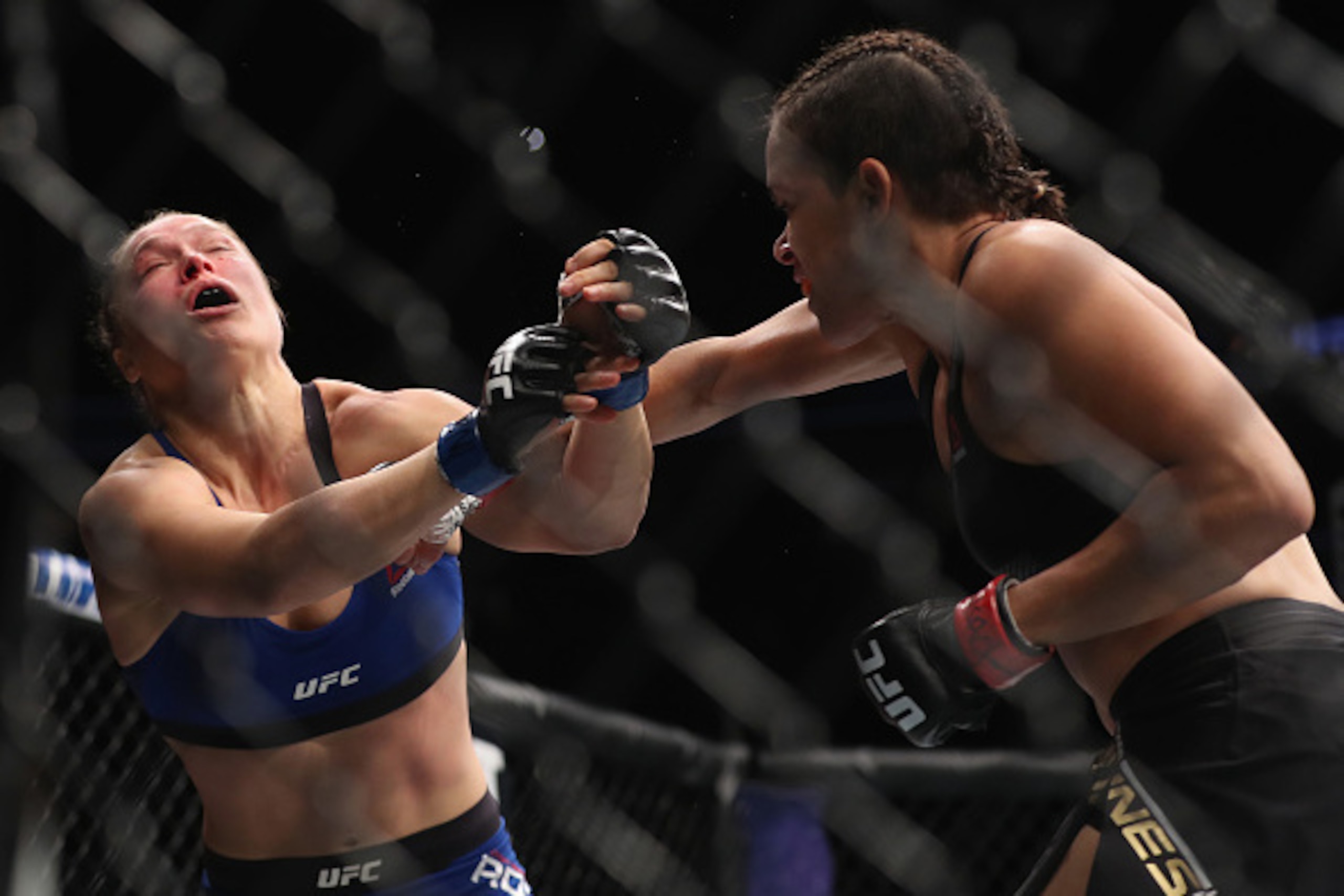 LAS VEGAS, NV - DECEMBER 30: (R-L) Amanda Nunes of Brazil punches Ronda Rousey in their UFC women's bantamweight championship bout during the UFC 207 event on December 30, 2016 in Las Vegas, Nevada.  (Photo by Christian Petersen/Getty Images)