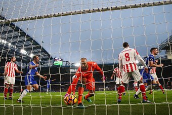LONDON, ENGLAND - DECEMBER 31:  Goalkeeper Lee Grant of Stoke City grabs the ball as Gary Cahill (R) of Chelsea celebrates as he scores the opening goal during the Premier League match between Chelsea and Stoke City at Stamford Bridge on December 31, 2016