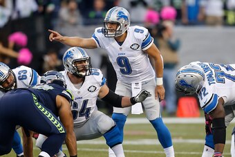 SEATTLE, WA - OCTOBER 5: Quarterback Matthew Stafford #9 of the Detroit Lions and center Travis Swanson #64 of the Detroit Lions make signals before a play during a football game against the Seattle Seahawks at CenturyLink Field on October 5, 2015 in Seat