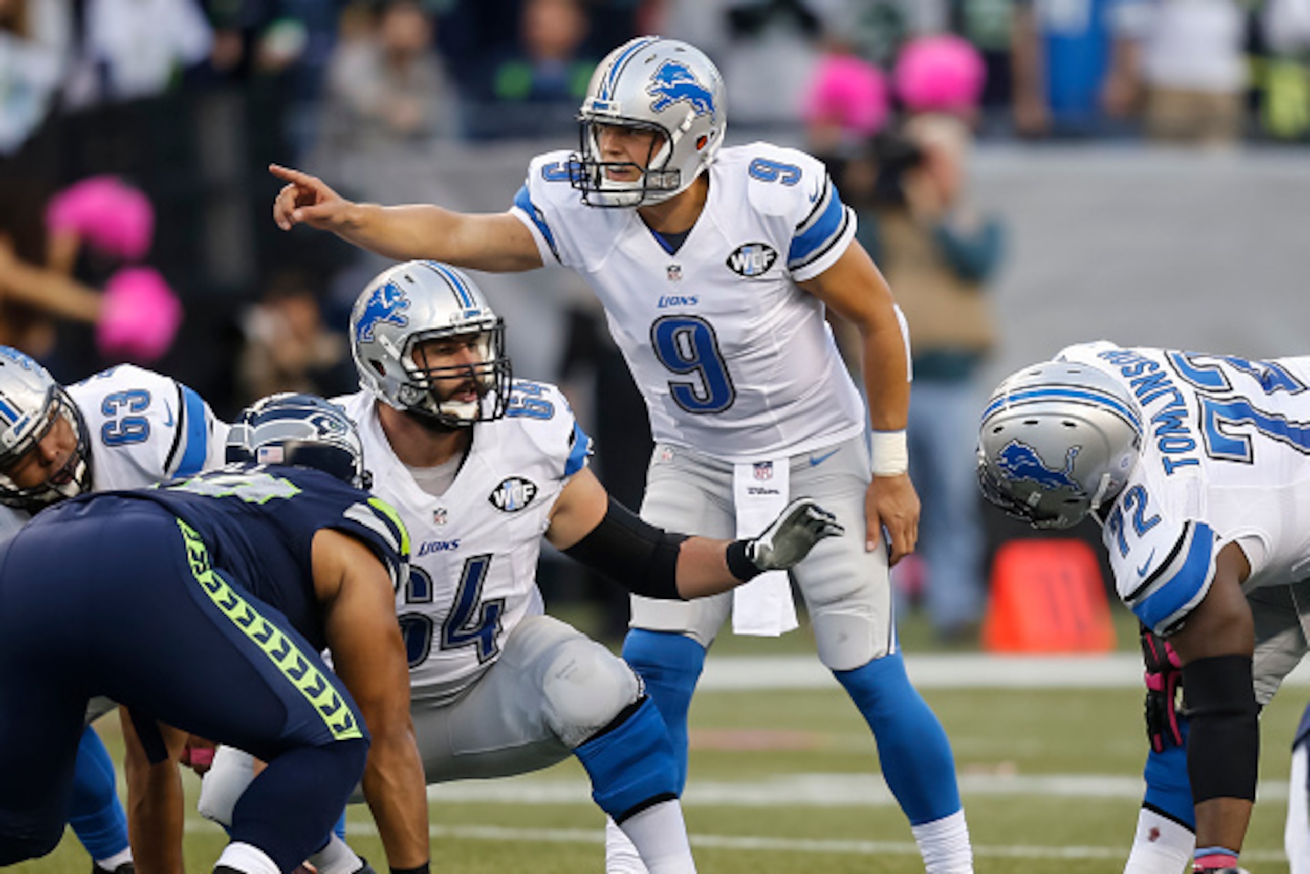 SEATTLE, WA - OCTOBER 5: Quarterback Matthew Stafford #9 of the Detroit Lions and center Travis Swanson #64 of the Detroit Lions make signals before a play during a football game against the Seattle Seahawks at CenturyLink Field on October 5, 2015 in Seat