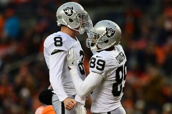 DENVER, CO - JANUARY 1:  Wide receiver Amari Cooper #89 of the Oakland Raiders celebrates his touchdown with quarterback Connor Cook #8 in the third quarter of the game against the Denver Broncos at Sports Authority Field at Mile High on January 1, 2017 i