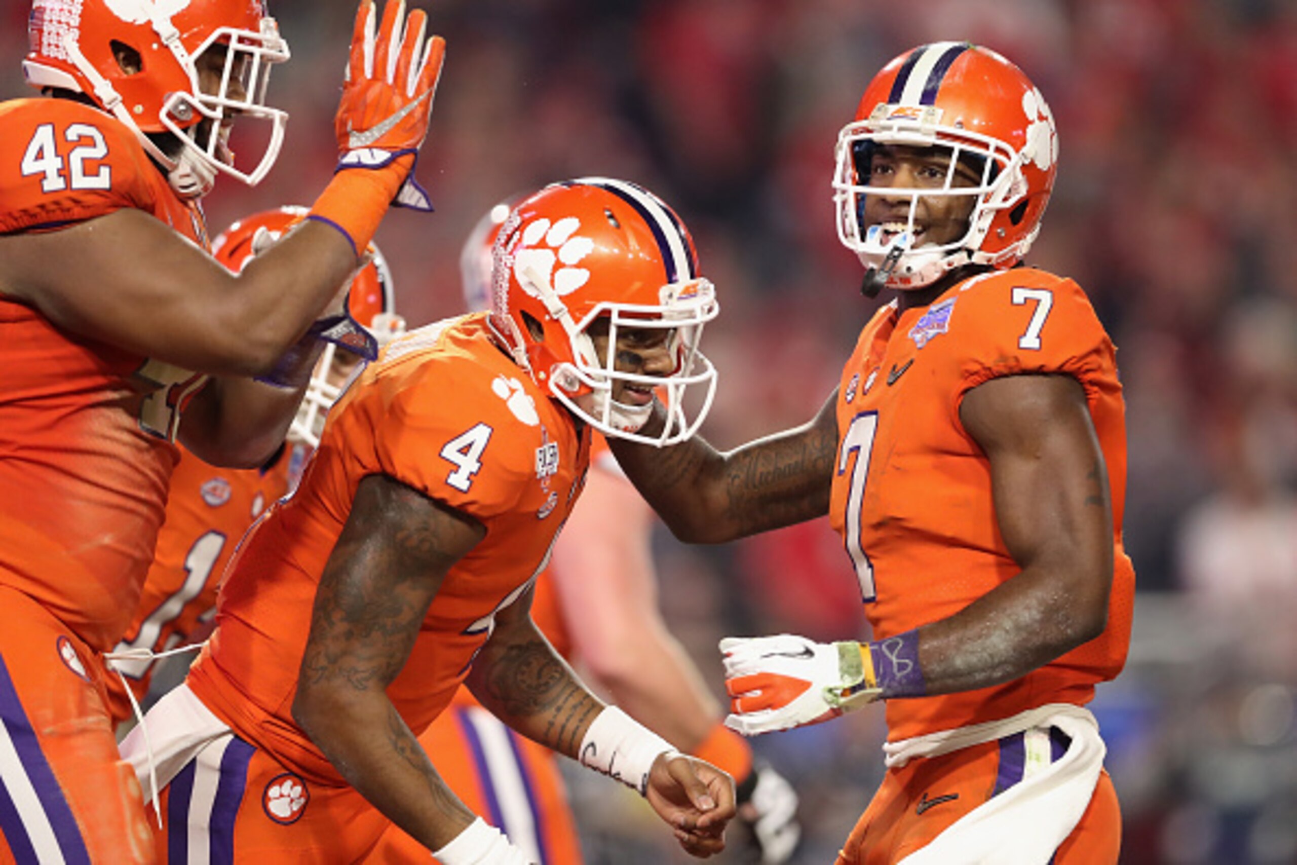 GLENDALE, AZ - DECEMBER 31:  Quarterback Deshaun Watson #4 (C) of the Clemson Tigers celebrates with Mike Williams #7 (R) and Christian Wilkins #42 after scoring on a one yard rushing touchdown against the Ohio State Buckeyes during the Playstation Fiesta