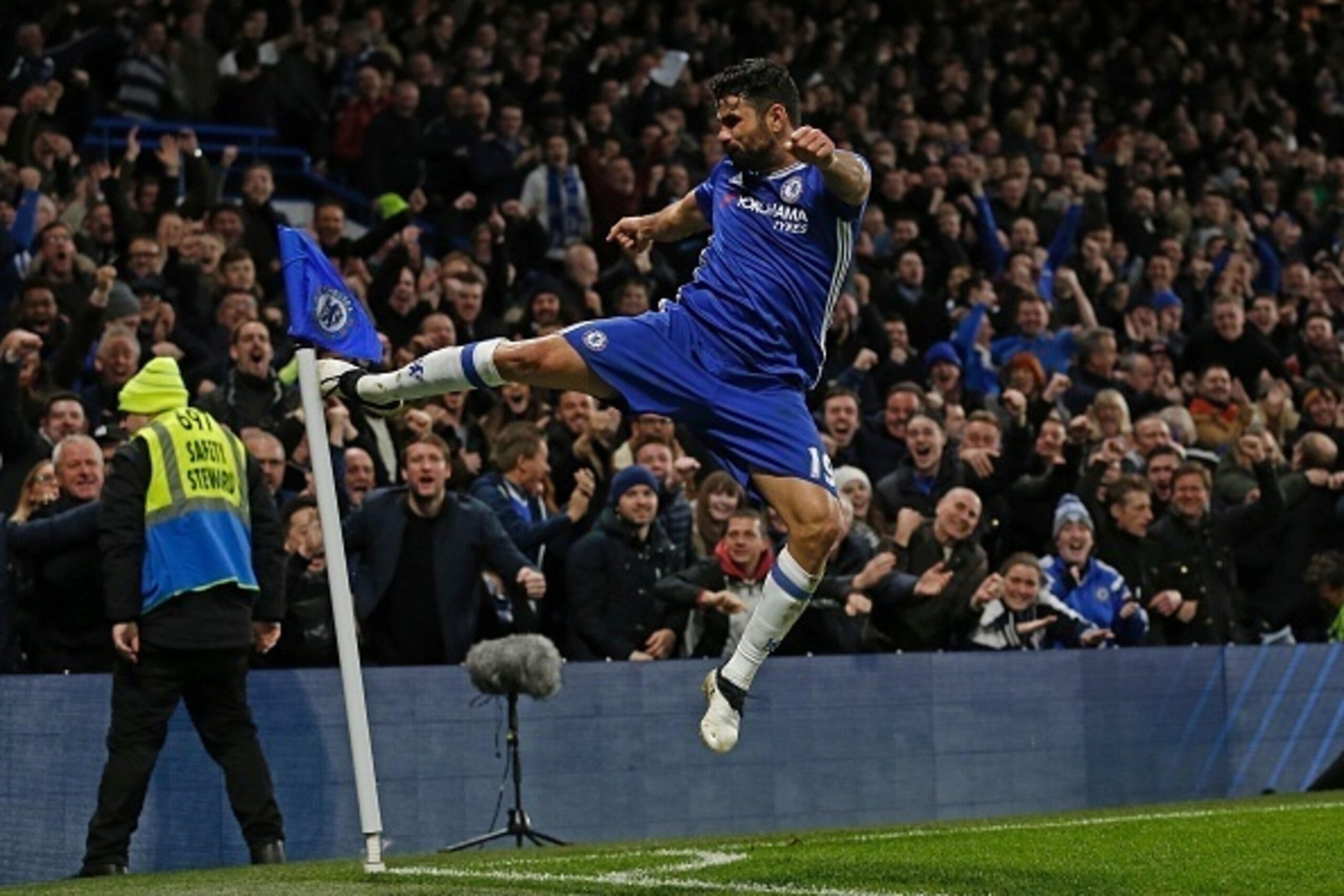 Chelsea's Brazilian-born Spanish striker Diego Costa celebrates after scoring their fourth goal during the English Premier League football match between Chelsea and Stoke City at Stamford Bridge in London on December 31, 2016.
Chelsea won the game 4-2. / 
