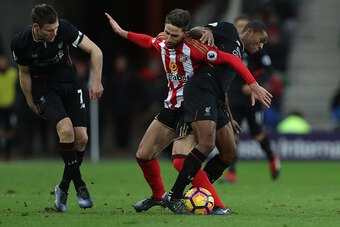 SUNDERLAND, ENGLAND - JANUARY 02: Fabio Borini of Sunderland (C) and Georginio Wijnaldum of Liverpool (R) battle for possession during the Premier League match between Sunderland and Liverpool at Stadium of Light on January 2, 2017 in Sunderland, England.
