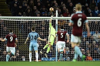 Manchester City's Chilean goalkeeper Claudio Bravo (C) jumps to make a save during the English Premier League football match between Manchester City and Burnley at the Etihad Stadium in Manchester, north west England, on January 2, 2017. / AFP / Oli SCARF