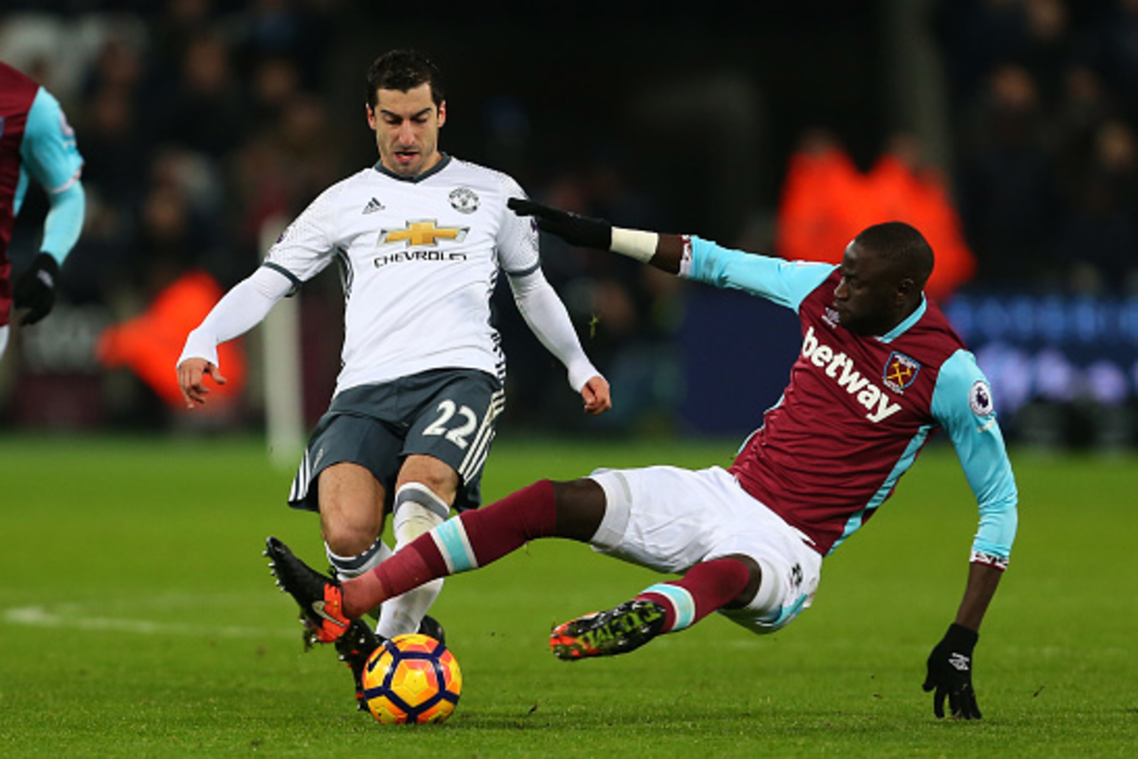 STRATFORD, ENGLAND - JANUARY 02: Cheikhou Kouyate of West Ham tackles Henrikh Mkhitaryan of Manchester United during the Premier League match between West Ham United and Manchester United at London Stadium on January 2, 2017 in Stratford, England. (Photo 