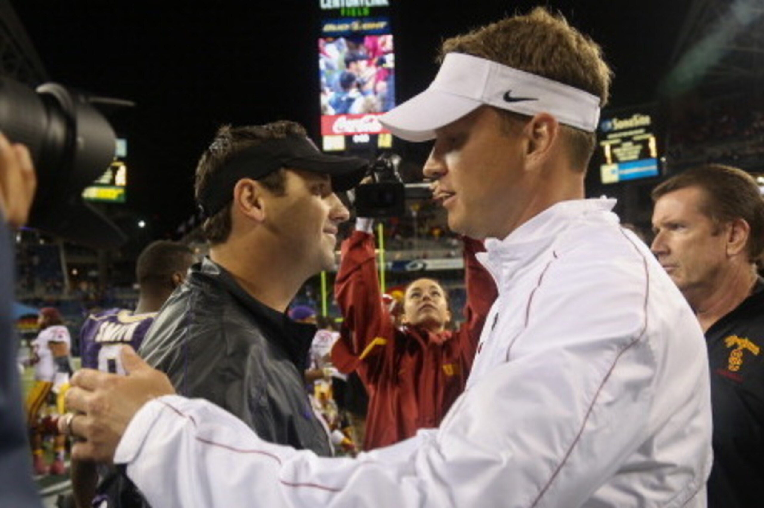 SEATTLE, WA - OCTOBER 13: Head coach Lane Kiffin (R) of the USC Trojans is congratulated by head coach Steve Sarkisian of the Washington Huskies after the Trojans defeated the Huskies 24-14 on October 13, 2012 at CenturyLink Field in Seattle, Washington. SEATTLE, WA - OCTOBER 13: Head coach Lane Kiffin (R) of the USC Trojans is congratulated by head coach Steve Sarkisian of the Washington Huskies after the Trojans defeated the Huskies 24-14 on October 13, 2012 at CenturyLink Field in Seattle, Washington.