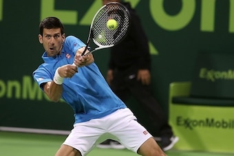Serbia's Novak Djokovic returns the ball to Jan-Lennard Struff of Germany, during the ATP Qatar Open tennis competition in Doha on January 2, 2017.  / AFP / KARIM JAAFAR        (Photo credit should read KARIM JAAFAR/AFP/Getty Images)