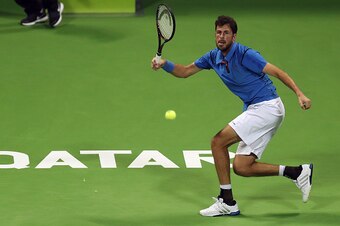 Robin Haase of the Netherlands returns the ball to Belgium's David Goffin, during the ATP Qatar Open tennis competition in Doha on January 2, 2017.  / AFP / KARIM JAAFAR        (Photo credit should read KARIM JAAFAR/AFP/Getty Images)