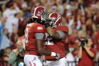 TUSCALOOSA, AL - NOVEMBER 13: Wide receiver Julio Jones #8 of the Alabama Crimson Tide celebrates a 56 yard touchdown with running back Mark Ingram #22 against the Mississippi State Bulldogs November 13, 2010 at Bryant-Denny Stadium in Tuscaloosa, Alabama