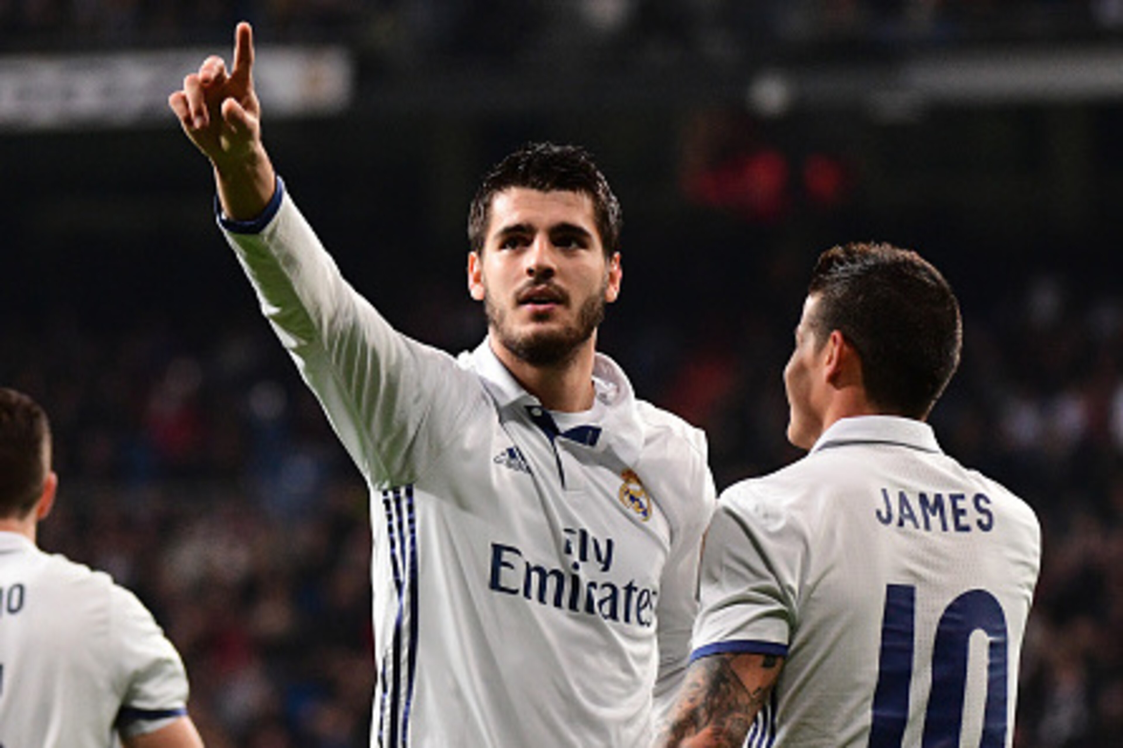 Real Madrid's forward Alvaro Morata (L) celebrates with Real Madrid's Colombian midfielder James Rodriguez after scoring during the Spanish league football match Real Madrid CF vs RC Deportivo at the Santiago Bernabeu stadium in Madrid on December 10, 201