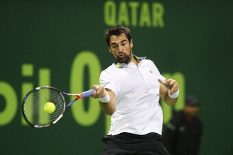 France's Jeremy Chardy retruns the ball to British player Andy Murray on the fourth day of the ATP Qatar Open tennis competition in Doha on January 3, 2017. / AFP / KARIM JAAFAR        (Photo credit should read KARIM JAAFAR/AFP/Getty Images)