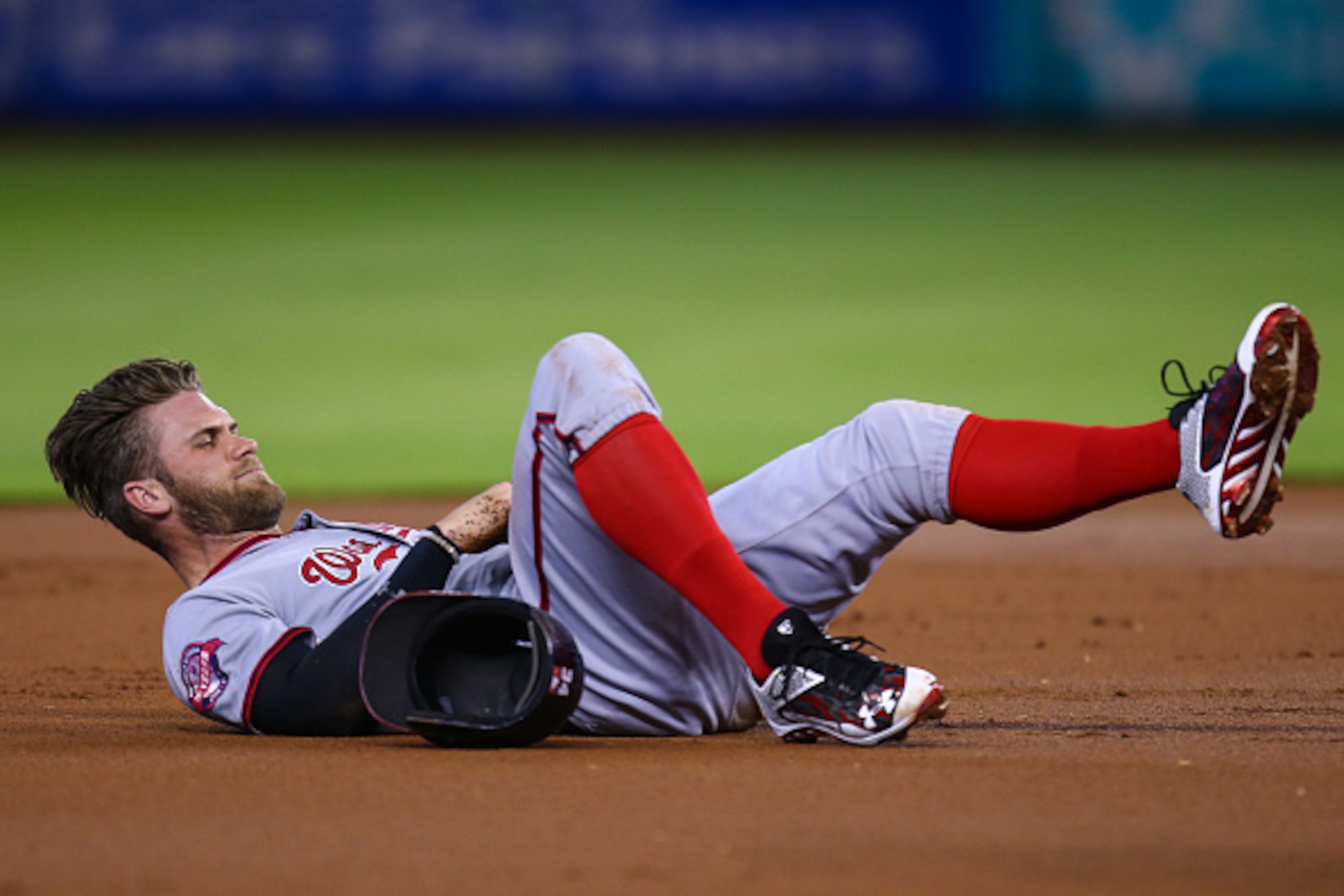 MIAMI, FL - SEPTEMBER 13: Bryce Harper #34 of the Washington Nationals lays injured on the infield after colliding with a Miami Marlins player during the first inning of the game at Marlins Park on September 13, 2015 in Miami, Florida. Harper was taken ou MIAMI, FL - SEPTEMBER 13: Bryce Harper #34 of the Washington Nationals lays injured on the infield after colliding with a Miami Marlins player during the first inning of the game at Marlins Park on September 13, 2015 in Miami, Florida. Harper was taken ou