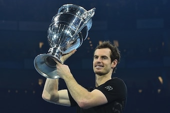 Britain's Andy Murray poses holding the ATP World Number One trophy after winning the men's singles final against Serbia's Novak Djokovic on the eighth and final day of the ATP World Tour Finals tennis tournament in London on November 20, 2016. / AFP / Gl
