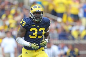 ANN ARBOR, MI - AUGUST 30: Taco Charlton #33 of the Michigan Wolverines looks to make the stop during the second half of the game against the Appalachian State Mountaineers on August 30, 2014 in Ann Arbor, Michigan. The Wolverines defeated the Mountaineer
