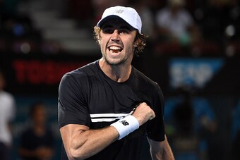 Australia's Jordan Thompson celebrates his victory over David Ferrer of Spain in the men's round second at the Brisbane International tennis tournament in Brisbane on January 4, 2017. / AFP / SAEED KHAN / IMAGE RESTRICTED TO EDITORIAL USE - STRICTLY NO CO