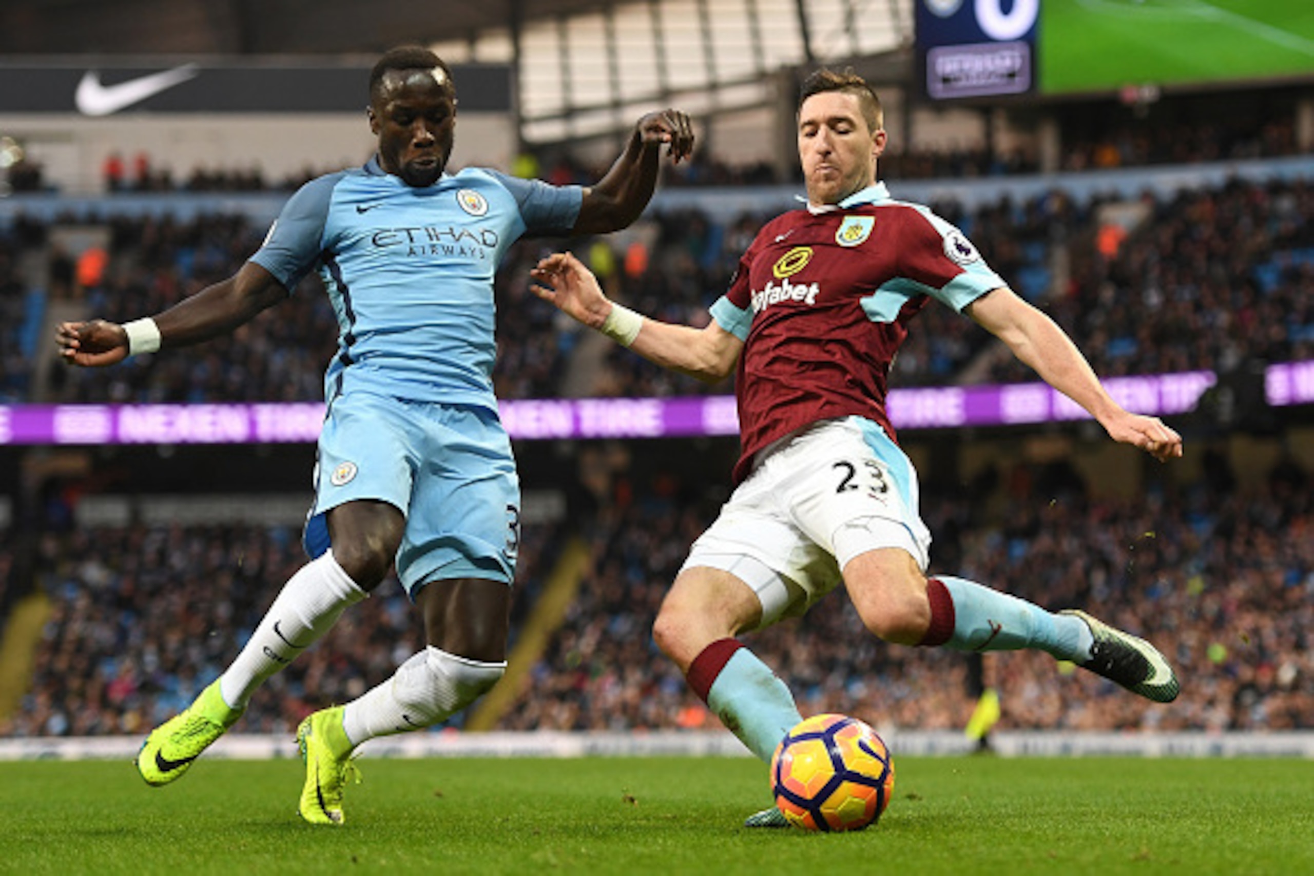 MANCHESTER, ENGLAND - JANUARY 02:  Bacary Sagna of Manchester City (L) and Stephen Ward of Burnley (R) battle for possession during the Premier League match between Manchester City and Burnley at Etihad Stadium on January 2, 2017 in Manchester, England.  
