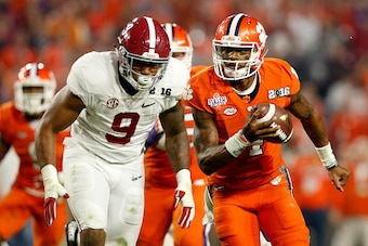 GLENDALE, AZ - JANUARY 11:  Deshaun Watson #4 of the Clemson Tigers runs the ball in the third quarter against Da'Shawn Hand #9 of the Alabama Crimson Tide during the 2016 College Football Playoff National Championship Game at University of Phoenix Stadiu