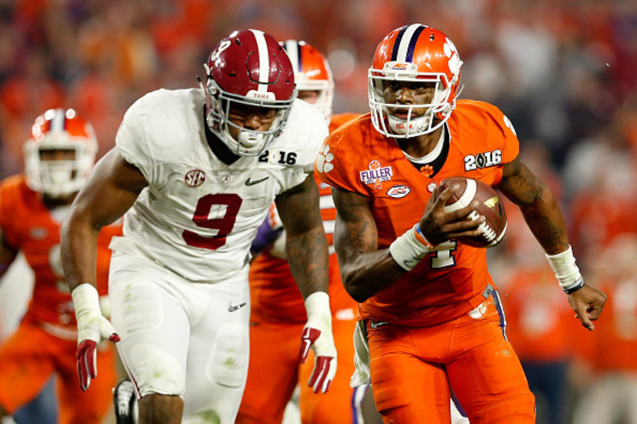 GLENDALE, AZ - JANUARY 11:  Deshaun Watson #4 of the Clemson Tigers runs the ball in the third quarter against Da'Shawn Hand #9 of the Alabama Crimson Tide during the 2016 College Football Playoff National Championship Game at University of Phoenix Stadiu