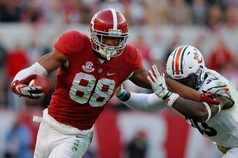 TUSCALOOSA, AL - NOVEMBER 26:  O.J. Howard #88 of the Alabama Crimson Tide attempts to break a tackle by Tre' Williams #30 of the Auburn Tigers at Bryant-Denny Stadium on November 26, 2016 in Tuscaloosa, Alabama.  (Photo by Kevin C. Cox/Getty Images)