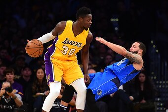LOS ANGELES, CA - DECEMBER 29:  Deron Williams #8 of the Dallas Mavericks draws a charge on Julius Randle #30 of the Los Angeles Lakers during the first half at Staples Center on December 29, 2016 in Los Angeles, California.  NOTE TO USER: User expressly 