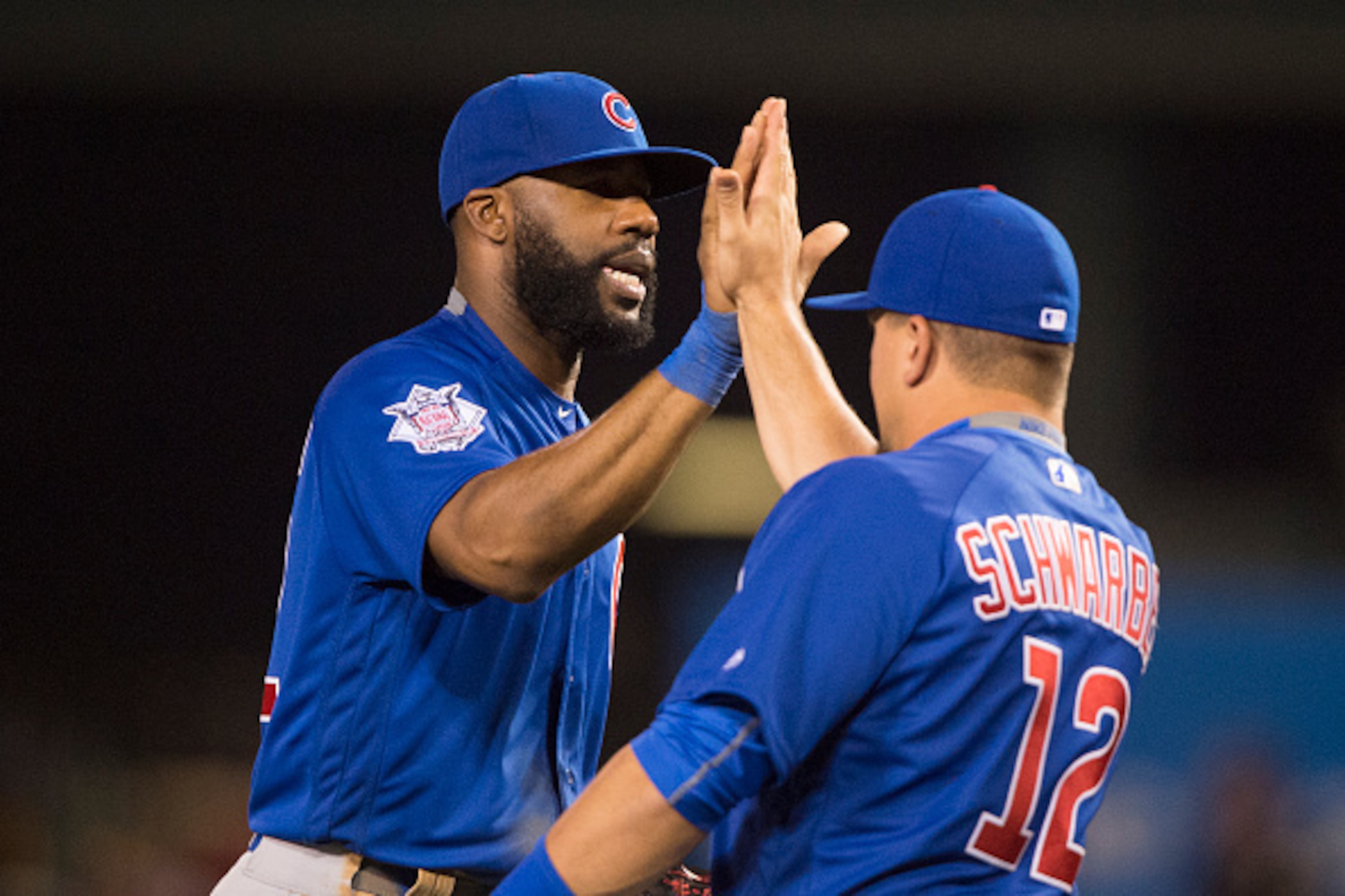 ANAHEIM, CA - APRIL 5: Jason Heyward #22 of the Chicago Cubs and teammate Kyle Schwarber #12 high five after defeating  the Los Angeles Angels of Anaheim at Angel Stadium of Anaheim on April 5, 2016 in Anaheim, California. (Photo by Matt Brown/Angels Base